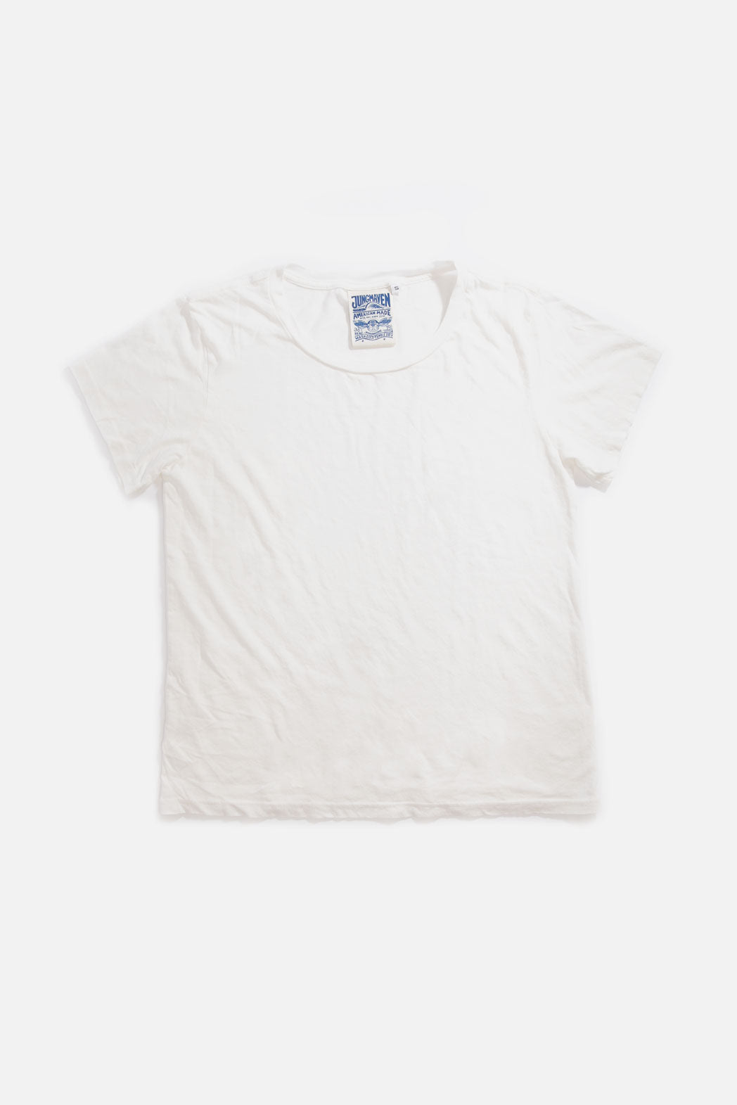 The Jungmaven Ojai Tee in Washed White, a unisex organic cotton t-shirt, is laid flat on a white background with a visible blue and white Jungmaven label inside the collar.