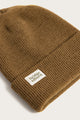 The Bridge & Burn Wool Watch Cap in Coyote is a brown knit beanie with a folded brim and a white rectangular Bridge & Burn label, shown on a light background.