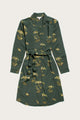 The Bridge & Burn Emery Shirt Dress in Woodland Bloom—a long-sleeve, knee-length shirtdress with a yellow and white floral print, button-down front, collar, and waist tie—is shown laid flat on a light background.
