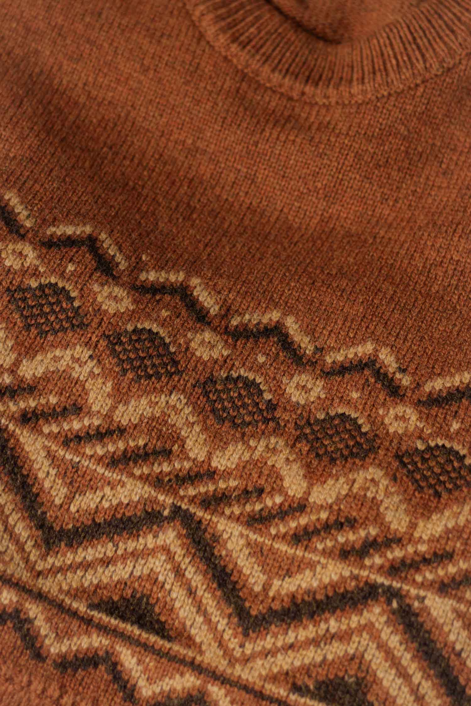 Close-up of the Bridge & Burn Rockwood Fairisle Sweater in Walnut Grove, showcasing geometric zigzag and diamond patterns in brown and beige. Textured stitches and a ribbed neckline reflect its RWS certified craftsmanship.