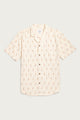 The Bridge & Burn Collins Slim Shirt in Dune Chevron is a cream, summerweight cotton button-up with a camp collar, red and brown geometric print, and single chest pocket, shown laid flat on a light background.