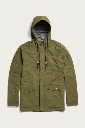 The Bridge & Burn Marshall Jacket in olive waxed canvas features water-resistant British Millerain fabric, a hood with black and white drawstrings and brown accents, front flap pockets, snap buttons, and zip closure.