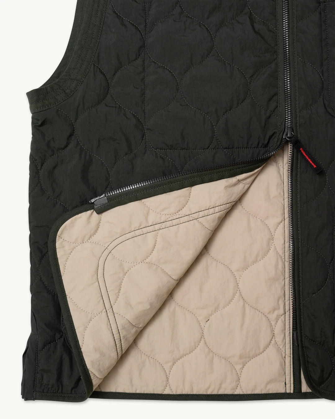 Dark green Imperfects - Shokunin Vest in Quilted Nylon / Greenroom featuring a partially open zipper revealing a tan interior lining.