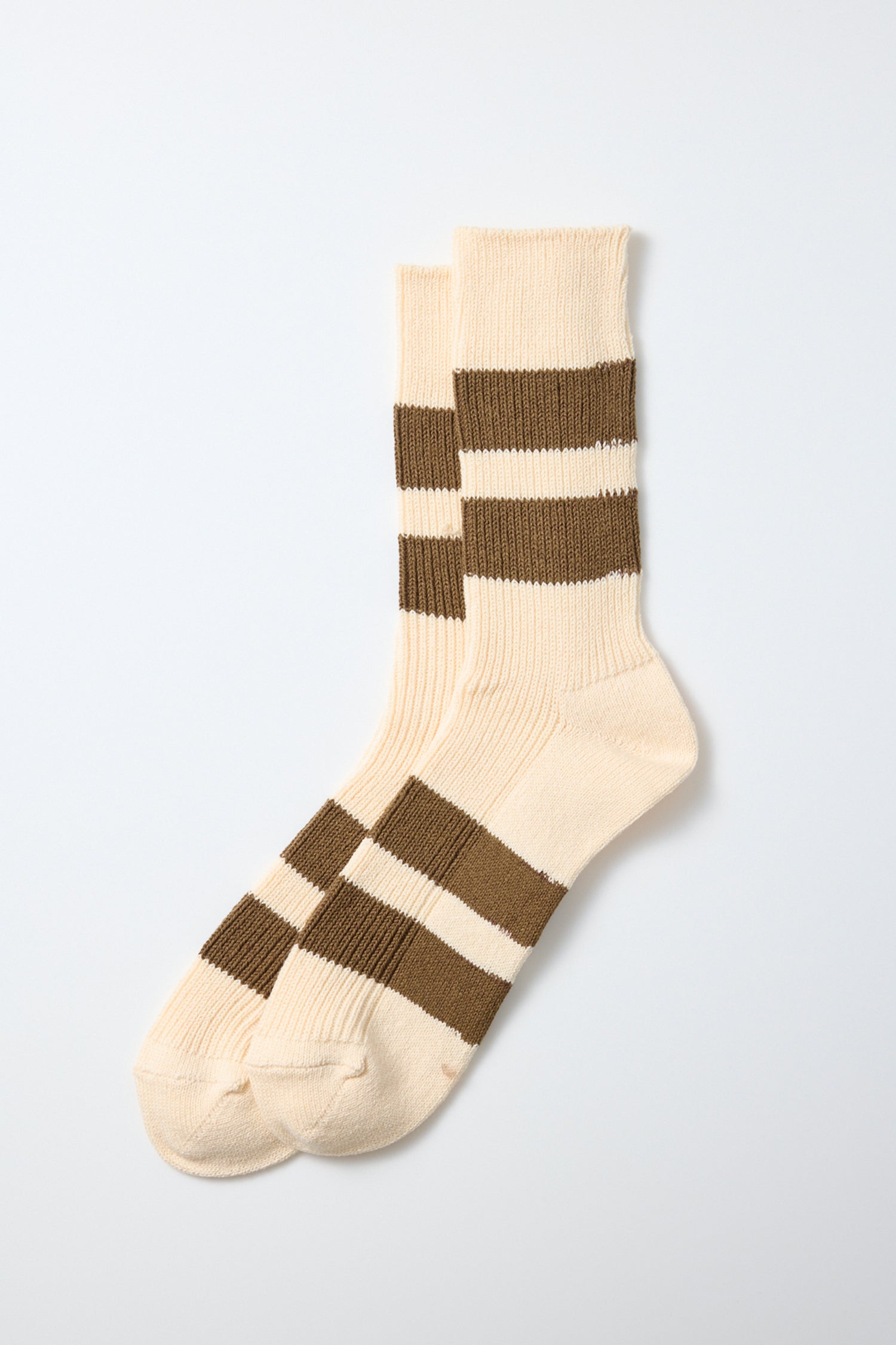 A pair of RoToTo Recycled Cotton Stripe Socks in Ecru Moss, featuring two thick horizontal brown stripes around the ankle and foot, crafted from recycled cotton socks material and made in Japan by RoToTo, displayed on a plain white background.